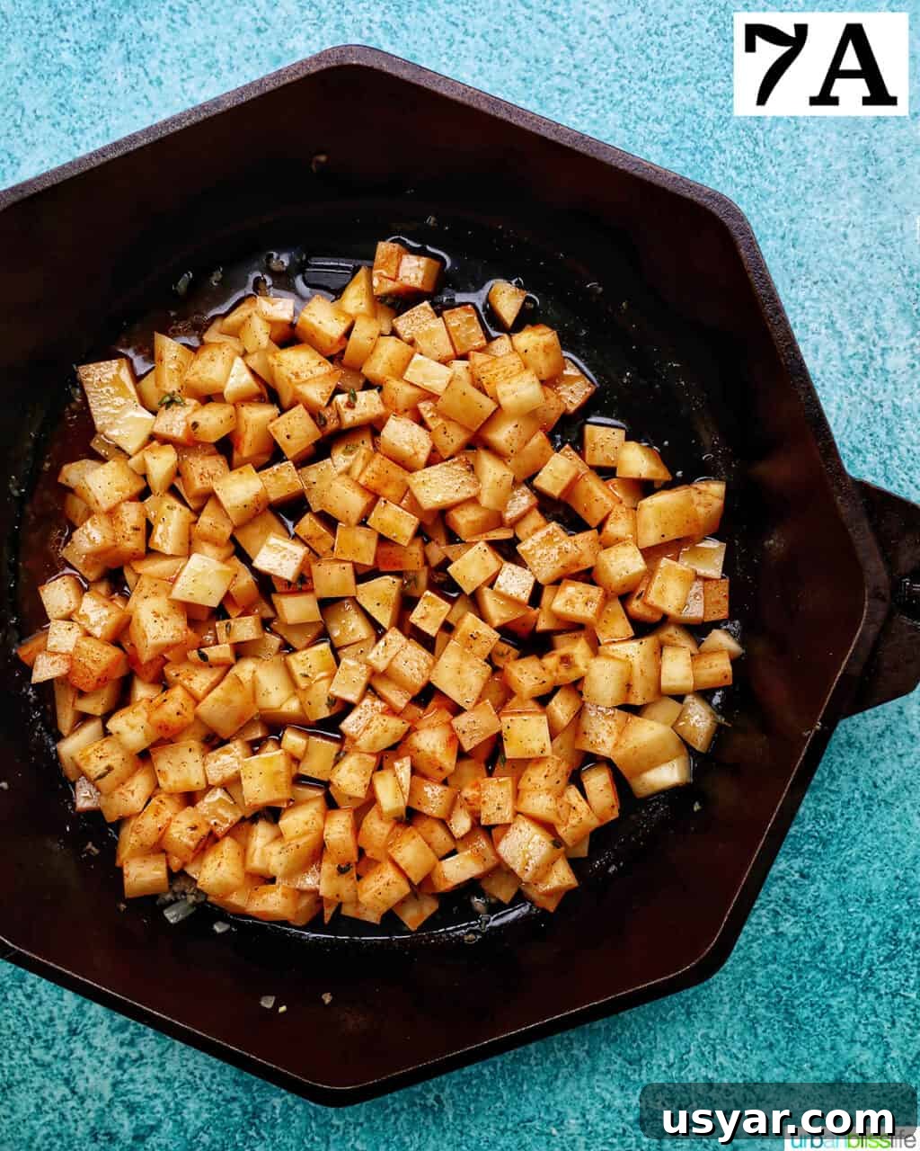 Breakfast Sausage and Potato Hash Recipe 15 Adding seasoned potatoes to skillet