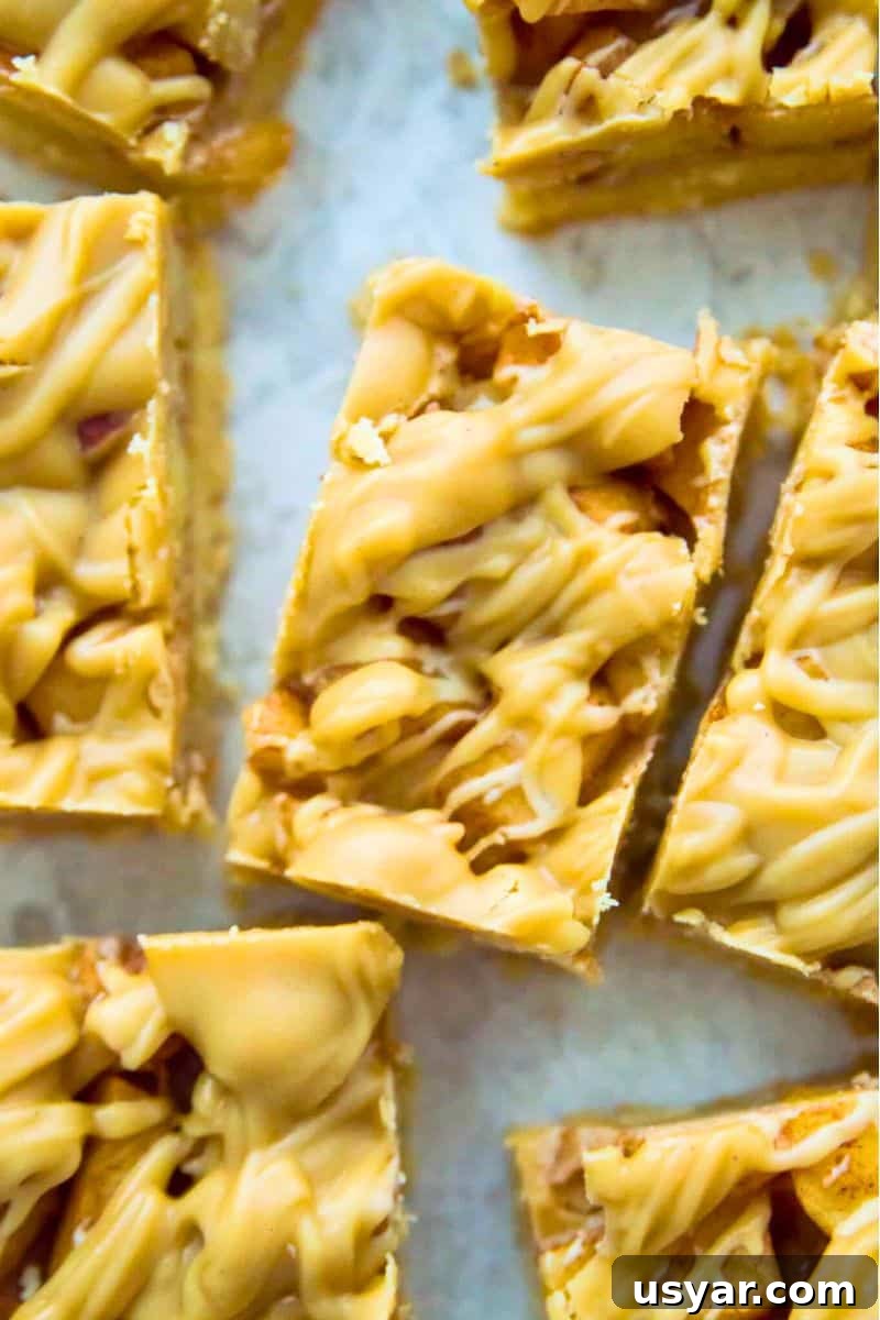 Gluten-Free Vegan and Paleo Apple Pie Bars 12 A batch of apple pie bars with a caramel topping cut into squares.