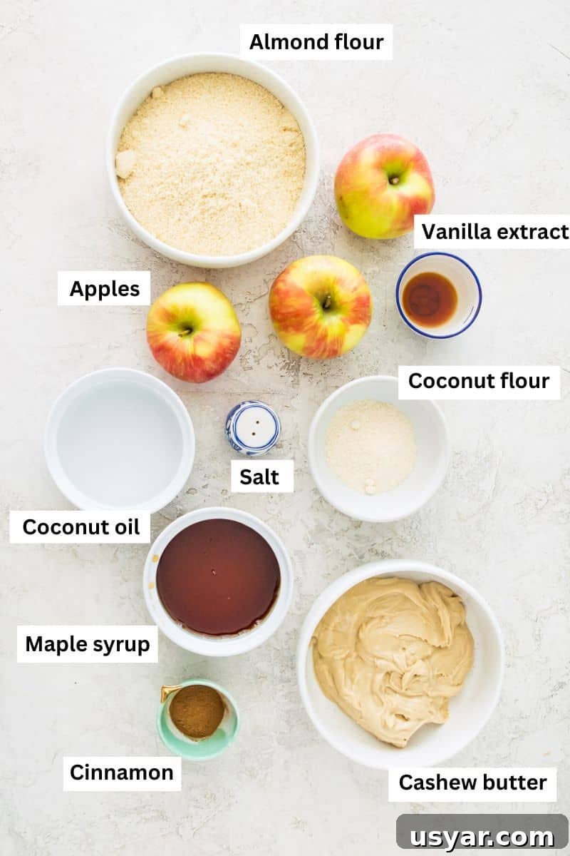 Gluten-Free Vegan and Paleo Apple Pie Bars 3 The ingredients needed to make apple pie bars in bowls including almond flour, apples, maple syrup, coconut oil and vanilla extract.
