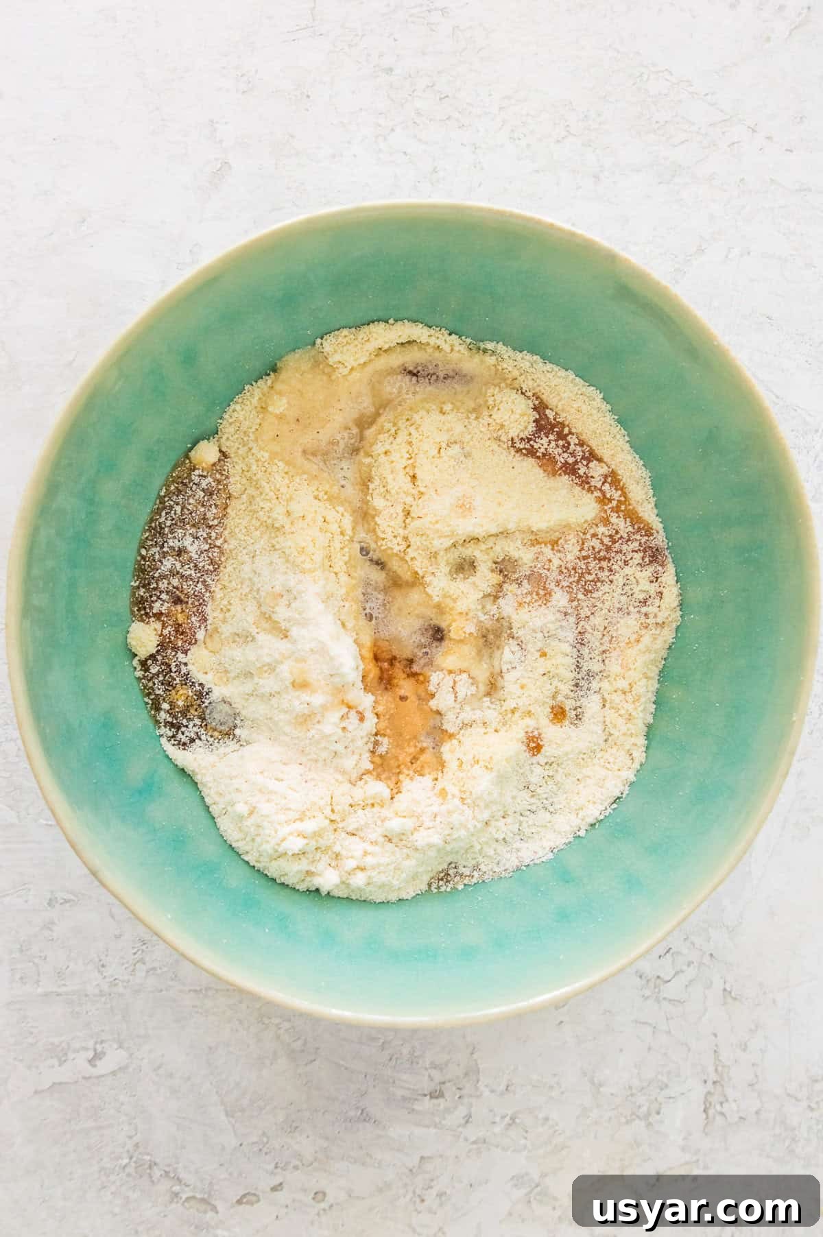 Gluten-Free Vegan and Paleo Apple Pie Bars 4 A bowl with almond flour, honey, coconut oil, and coconut flour in it.