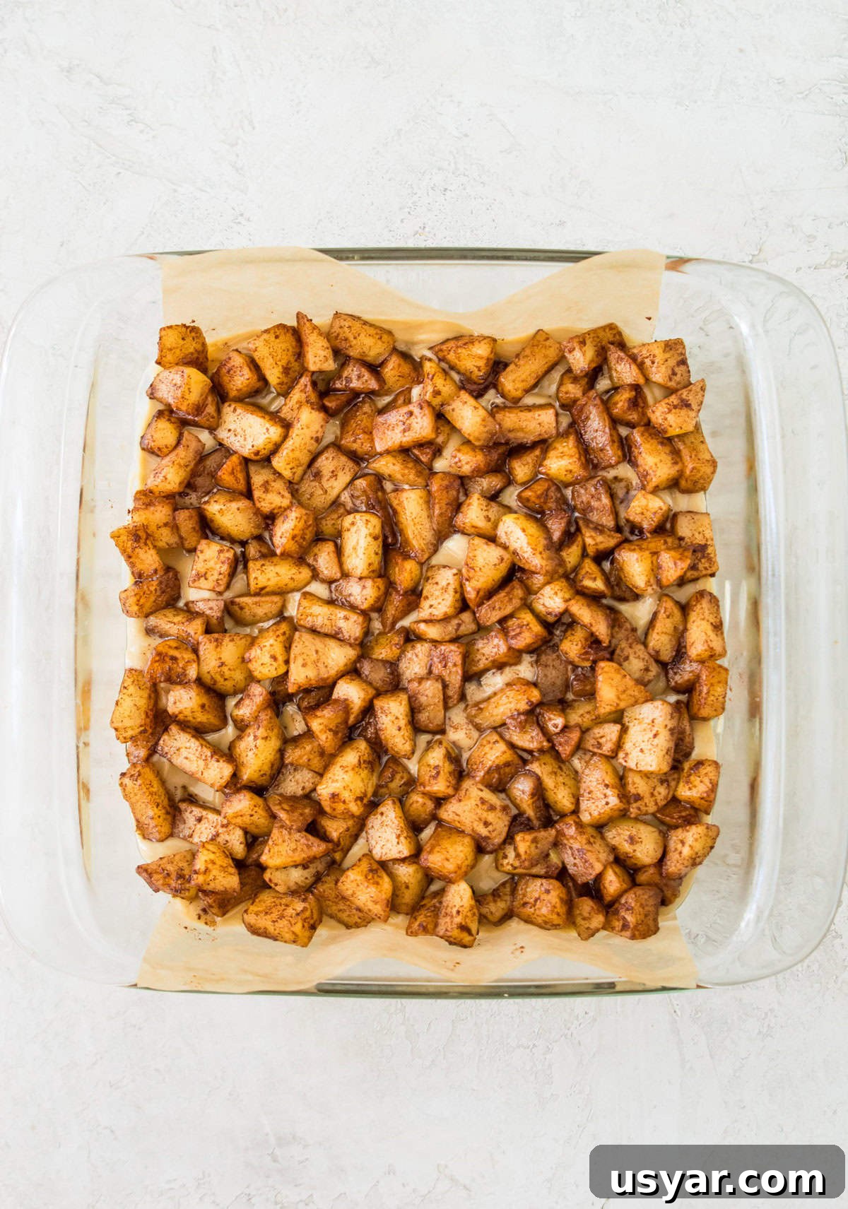 Gluten-Free Vegan and Paleo Apple Pie Bars 9 A square baking pan with cooked apple pieces in it.