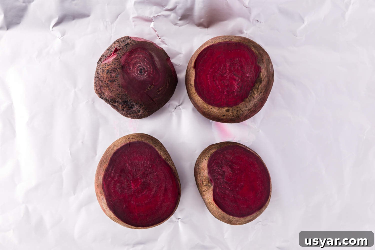 Roasted Beets Recipe with Balsamic and Goat Cheese 9 Uncooked beets, sitting on a sheet of foil.