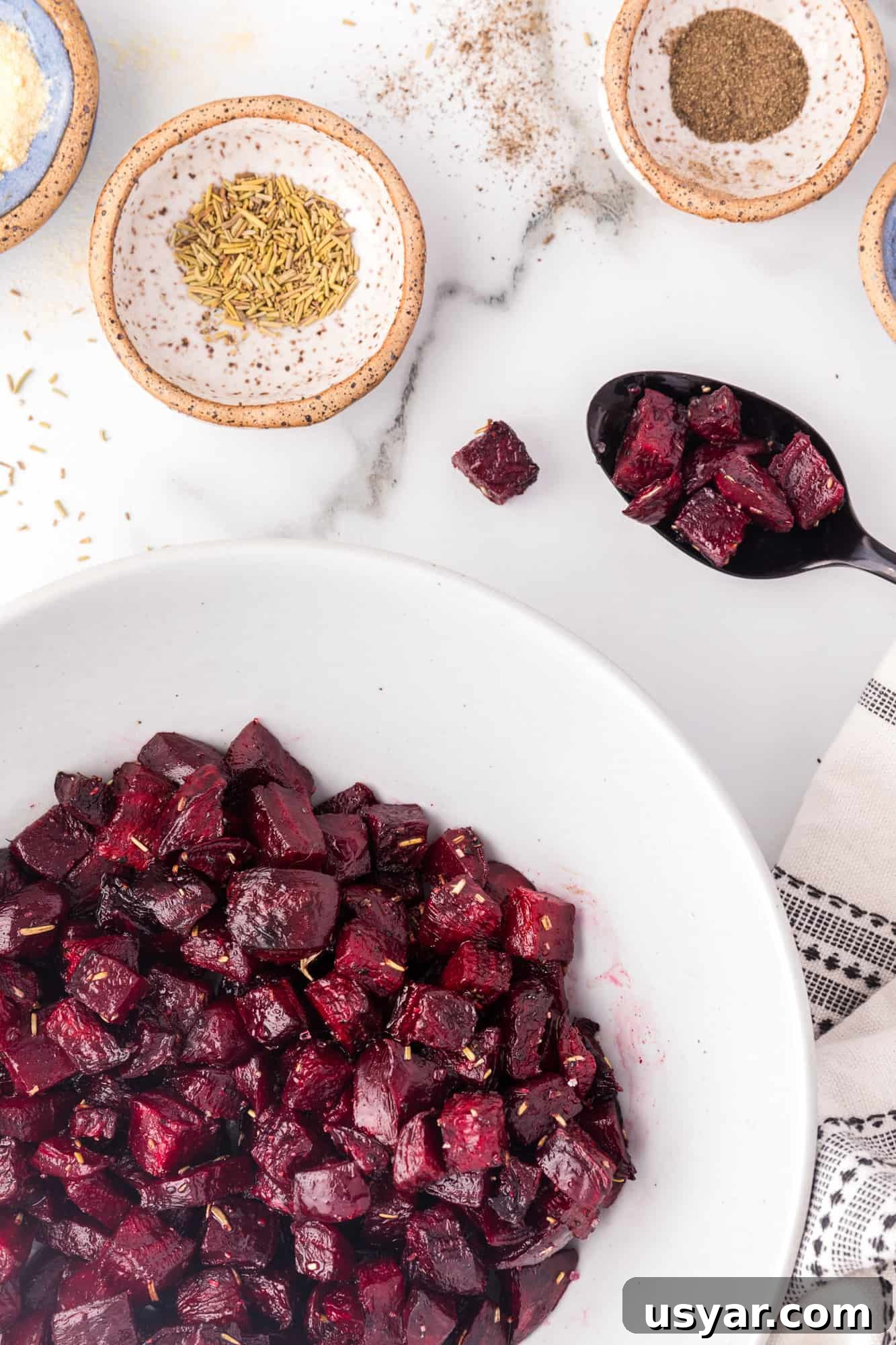 Roasted Beets Recipe with Balsamic and Goat Cheese 3 Roasted beets in a white bowl.