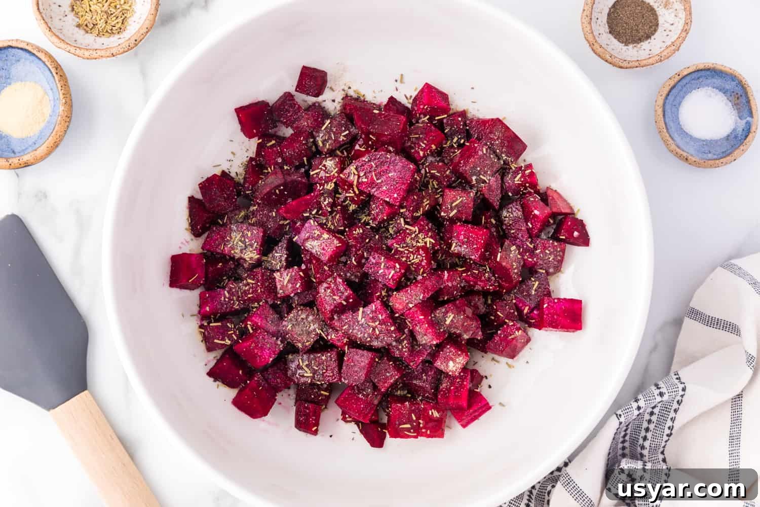 Roasted Beets Recipe with Balsamic and Goat Cheese 8 Cubed beets in a bowl, seasoned, but not yet cooked.
