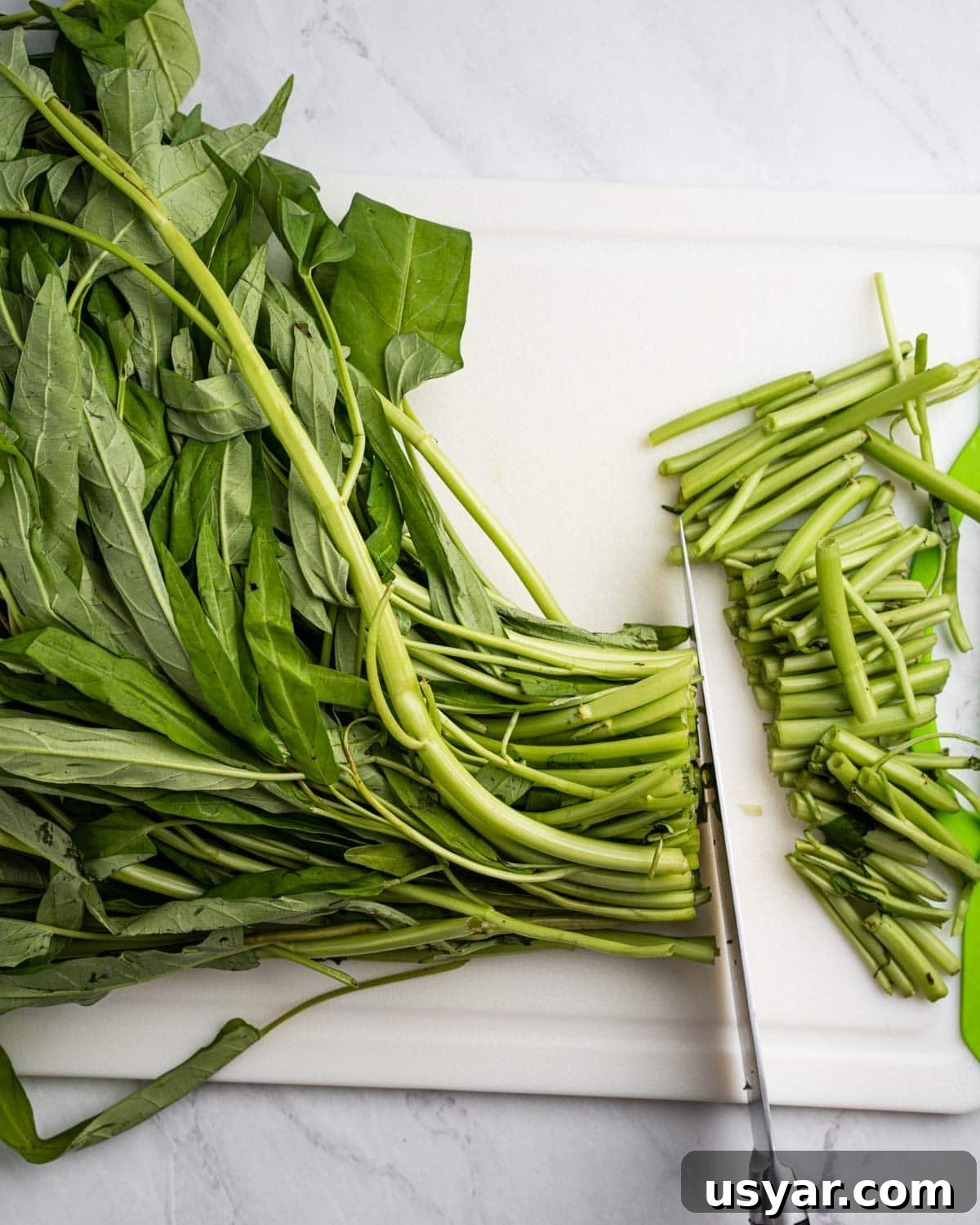 Vietnamese Garlic Water Spinach Stir Fry 4 Knife chopping the ends off of the rau muong.