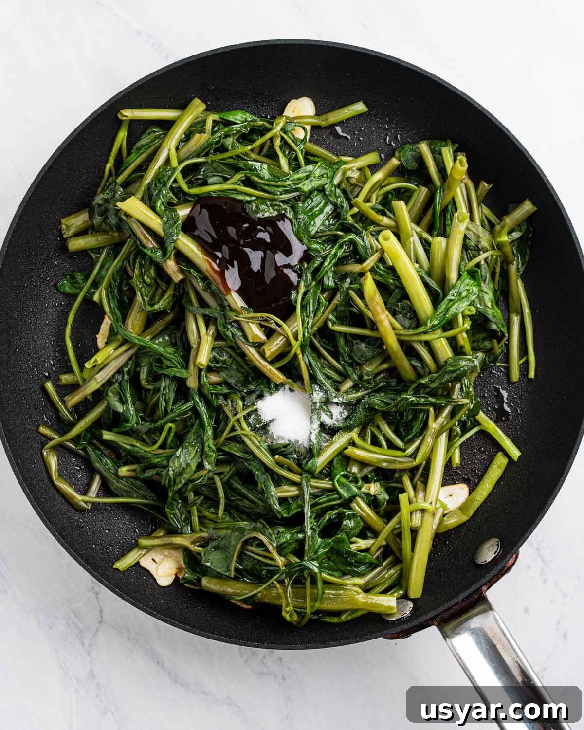 Vietnamese Garlic Water Spinach Stir Fry 9 Pan with blanched water spinach, sautéed garlic slices, oyster sauce and sugar.