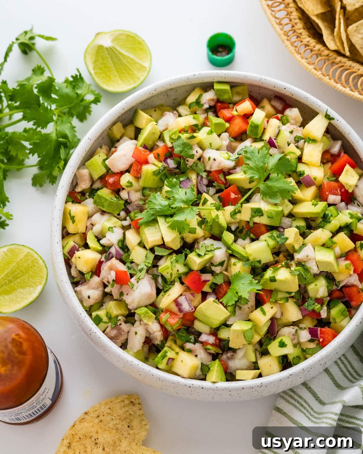Serving a bowl of ceviche with accompaniments.