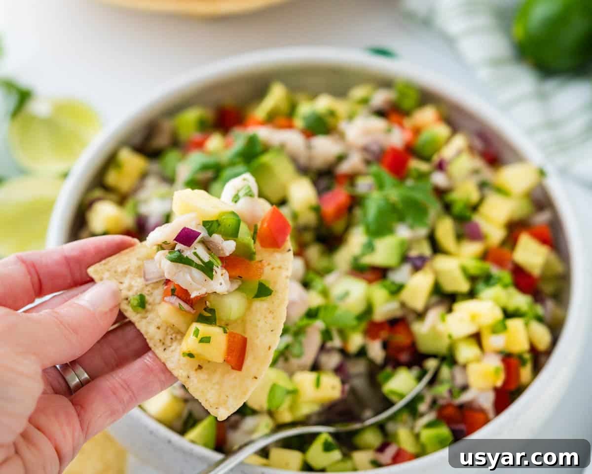 Scooping the ceviche on a tortilla chip.