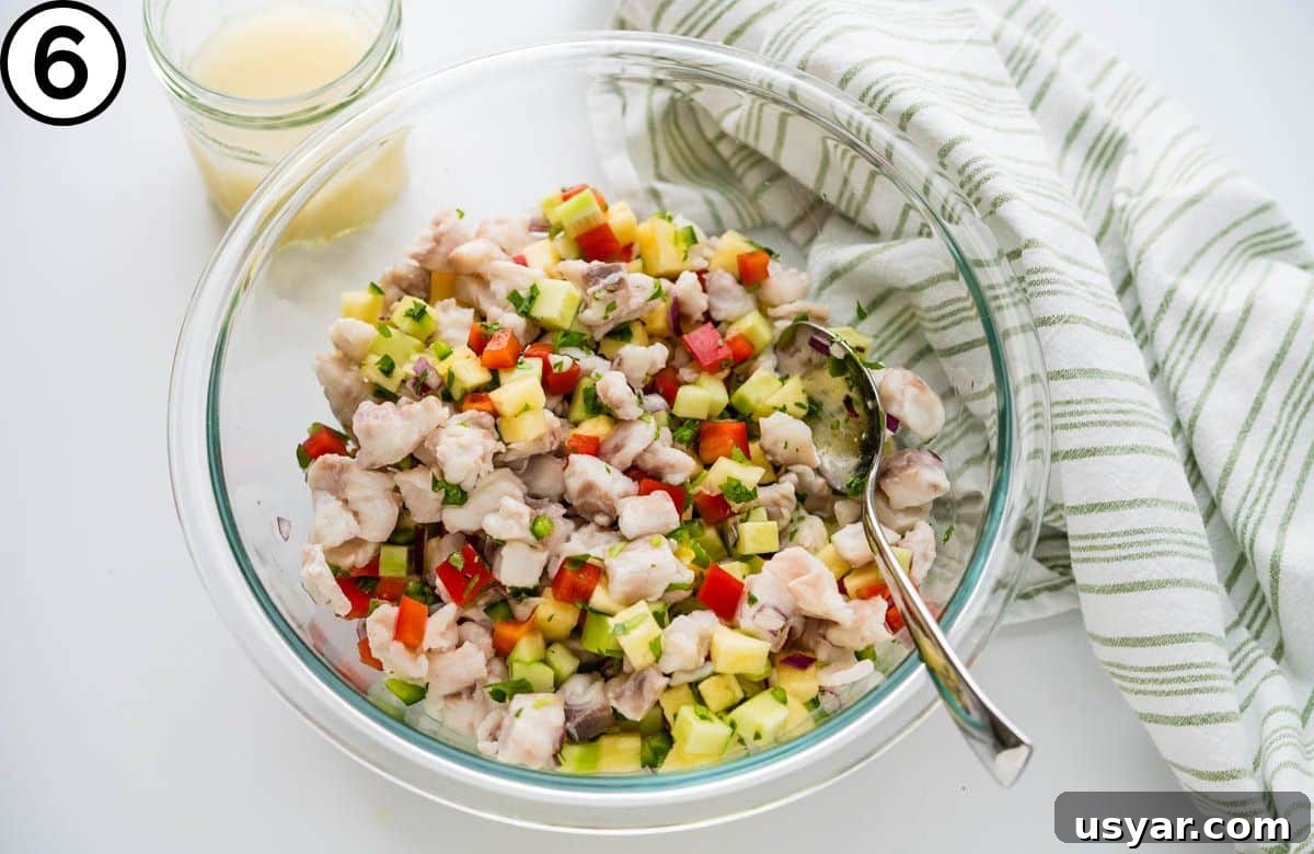 Adding fish and a little of the citrus juices back to the ceviche.