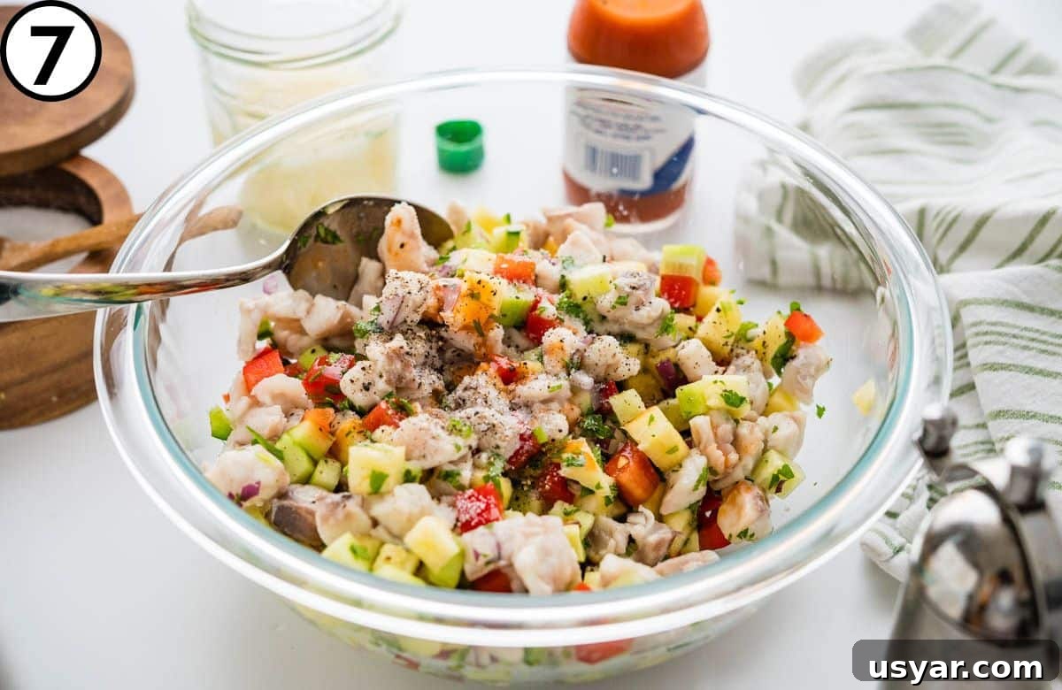 Seasoning the ceviche with salt, pepper and hot sauce.