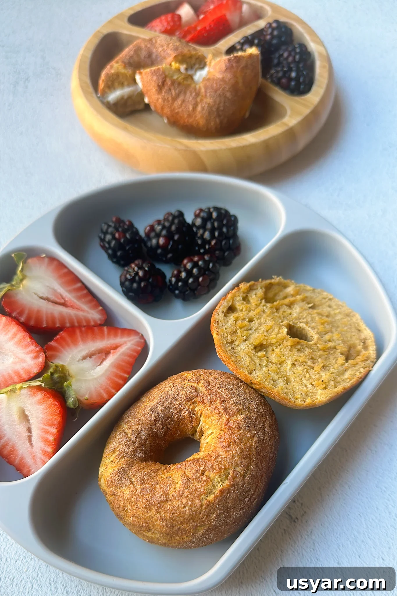 Homemade Pumpkin Bagels Recipe with Cinnamon and Nutmeg 2 Mini pumpkin bagels served with berries.
