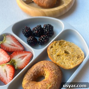 Homemade Pumpkin Bagels Recipe with Cinnamon and Nutmeg 13 Mini pumpkin bagels served with berries.