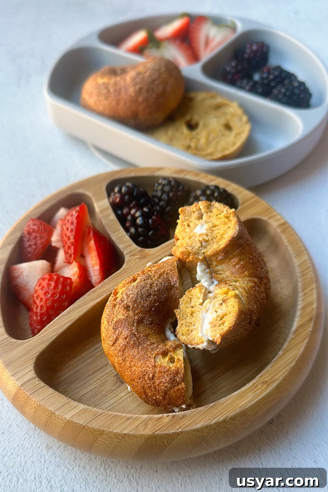 Homemade Pumpkin Bagels Recipe with Cinnamon and Nutmeg 7 Mini pumpkin bagels served with berries.