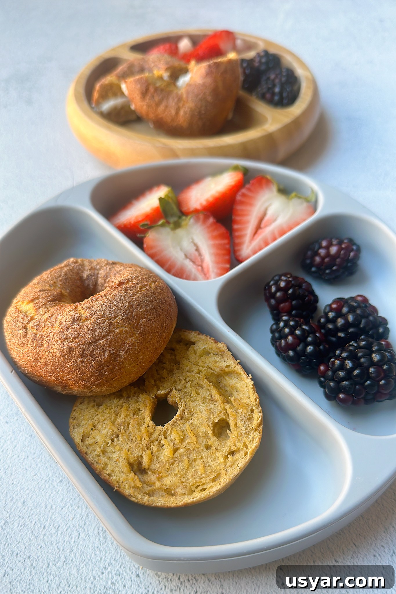 Homemade Pumpkin Bagels Recipe with Cinnamon and Nutmeg 8 Mini pumpkin bagels served with berries.