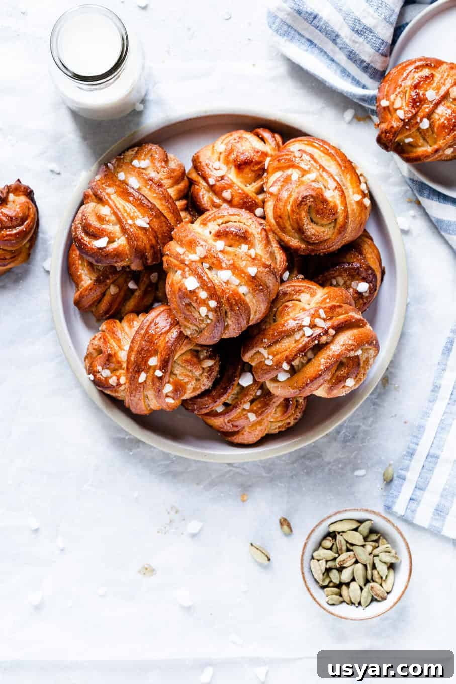 Swedish Cardamom Buns Recipe 2 overhead shot of a plate with golden cardamom buns
