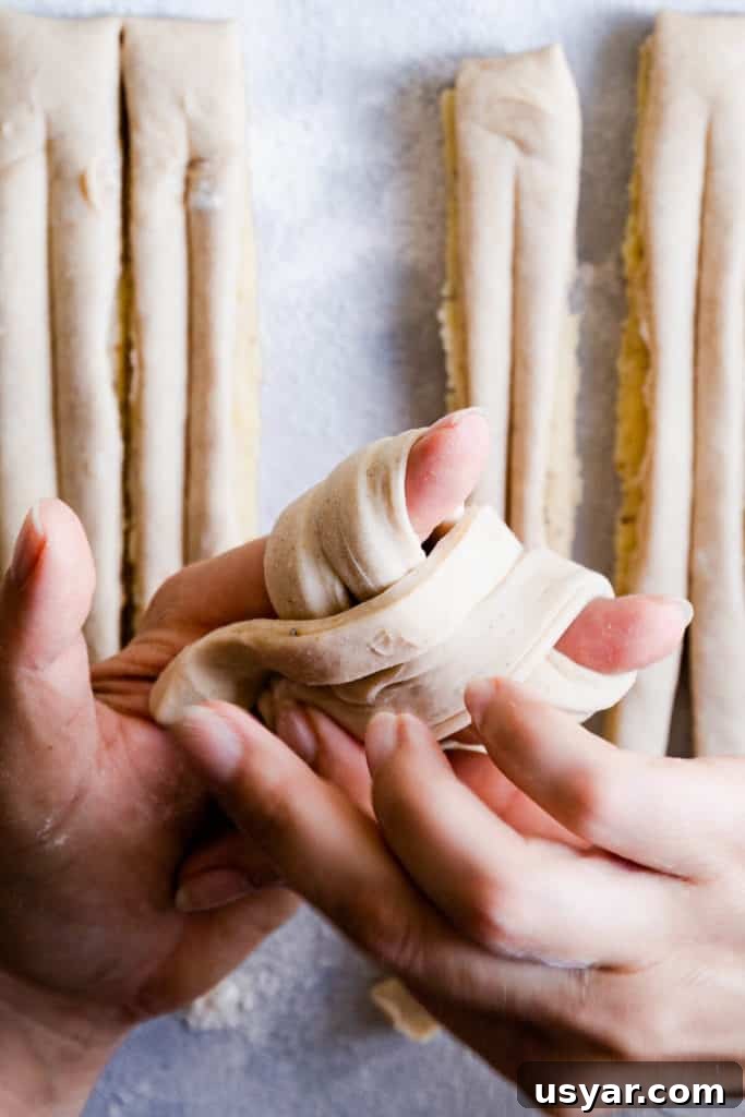 Swedish Cardamom Buns Recipe 15 close up of hands shaping the dough