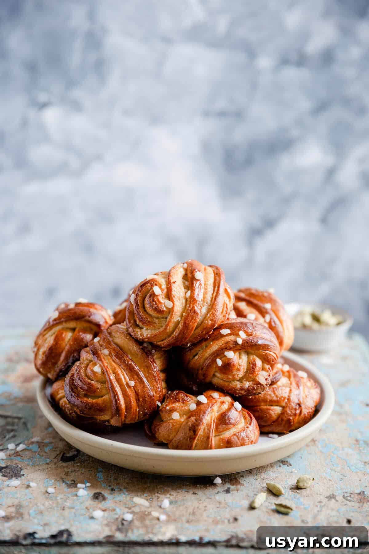 Swedish Cardamom Buns Recipe 5 side shot of a plate with cardamom buns
