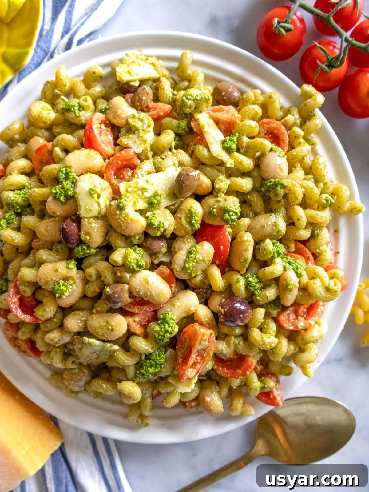 Pesto Pasta Salad with Marinated Butter Beans Recipe 2 Top down pesto pasta salad with butter beans basil olives and lemon zest.