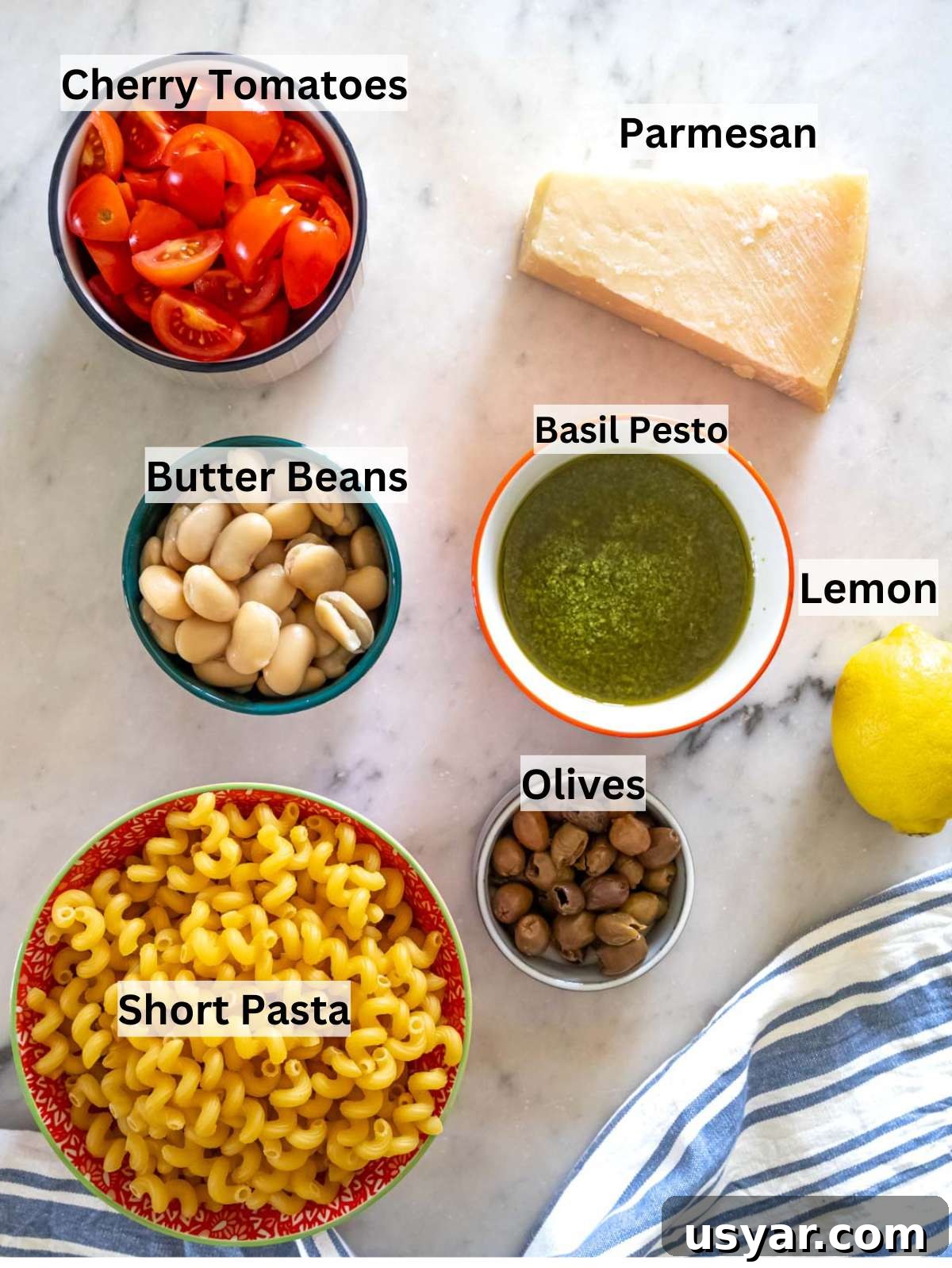 Pesto Pasta Salad with Marinated Butter Beans Recipe 4 Ingredients for pesto pasta salad with marinated butter beans pasta tomatoes olives parmesan and lemon.