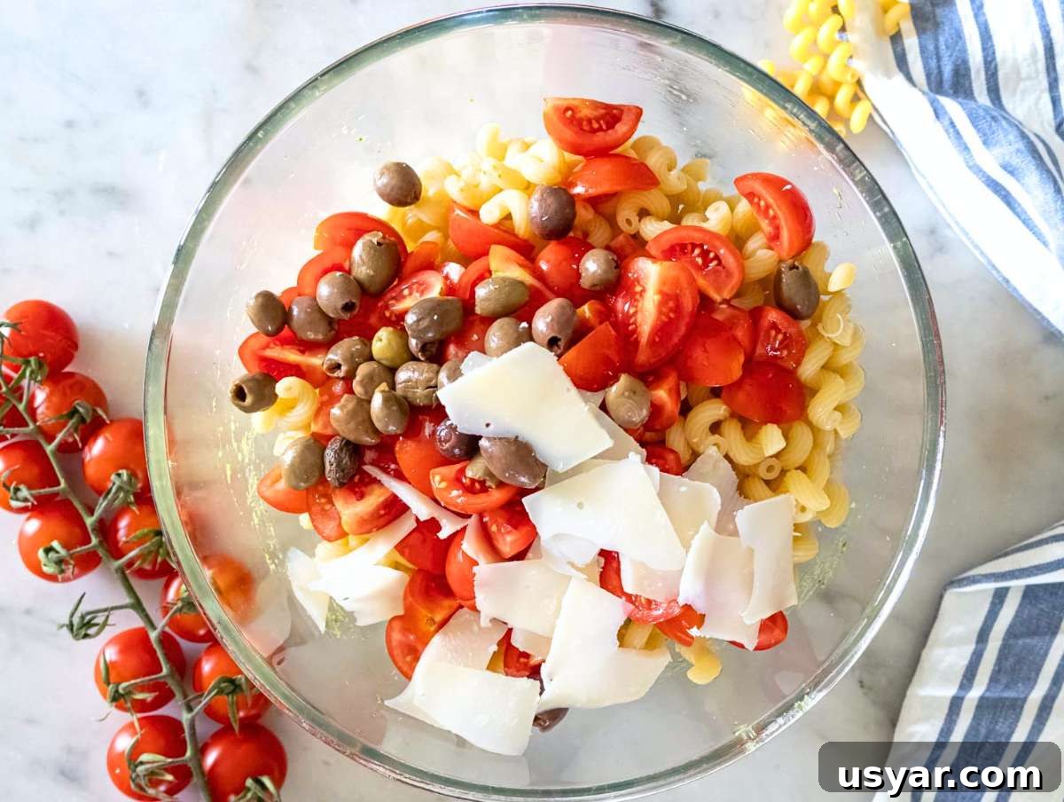 Pesto Pasta Salad with Marinated Butter Beans Recipe 7 Step 3 Pasta cherry tomatoes parmesan and olives added to the bowl with the marinated beans.