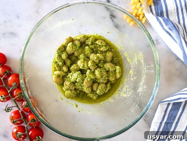 Pesto Pasta Salad with Marinated Butter Beans Recipe 10 Step 1 Marinating butter beans with pesto lemon zest and juice in a mixing bowl.