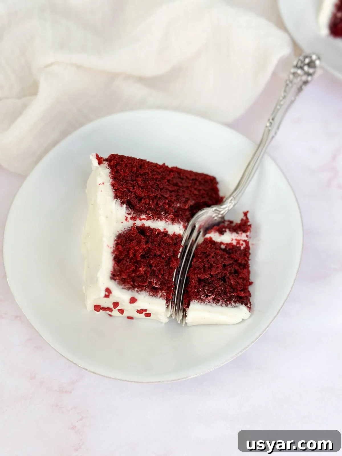 Mini Red Velvet Cake with Cream Cheese Frosting 2 a single slice of the small red velvet cake on a plate.