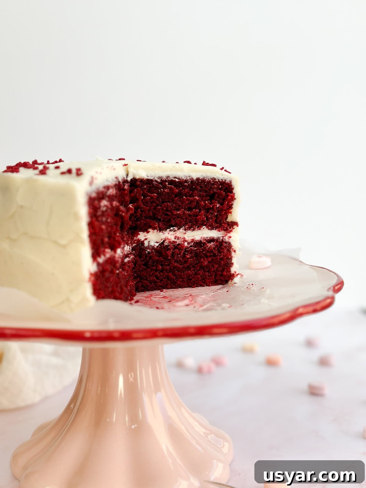 Mini Red Velvet Cake with Cream Cheese Frosting 11 the whole small red velvet cake with some pieces missing to see inside.