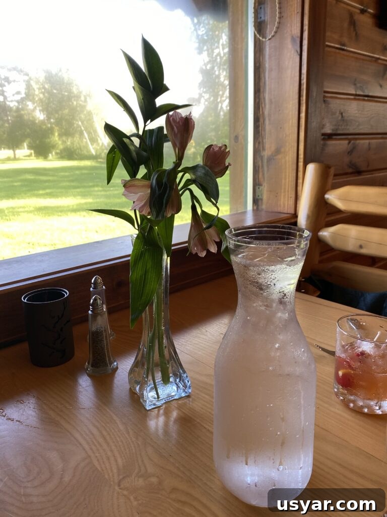 Chef Rene's at The Inn: Seasonal Cuisine in Eagle River, WI 22 A table by the window with water and flowers in a vase