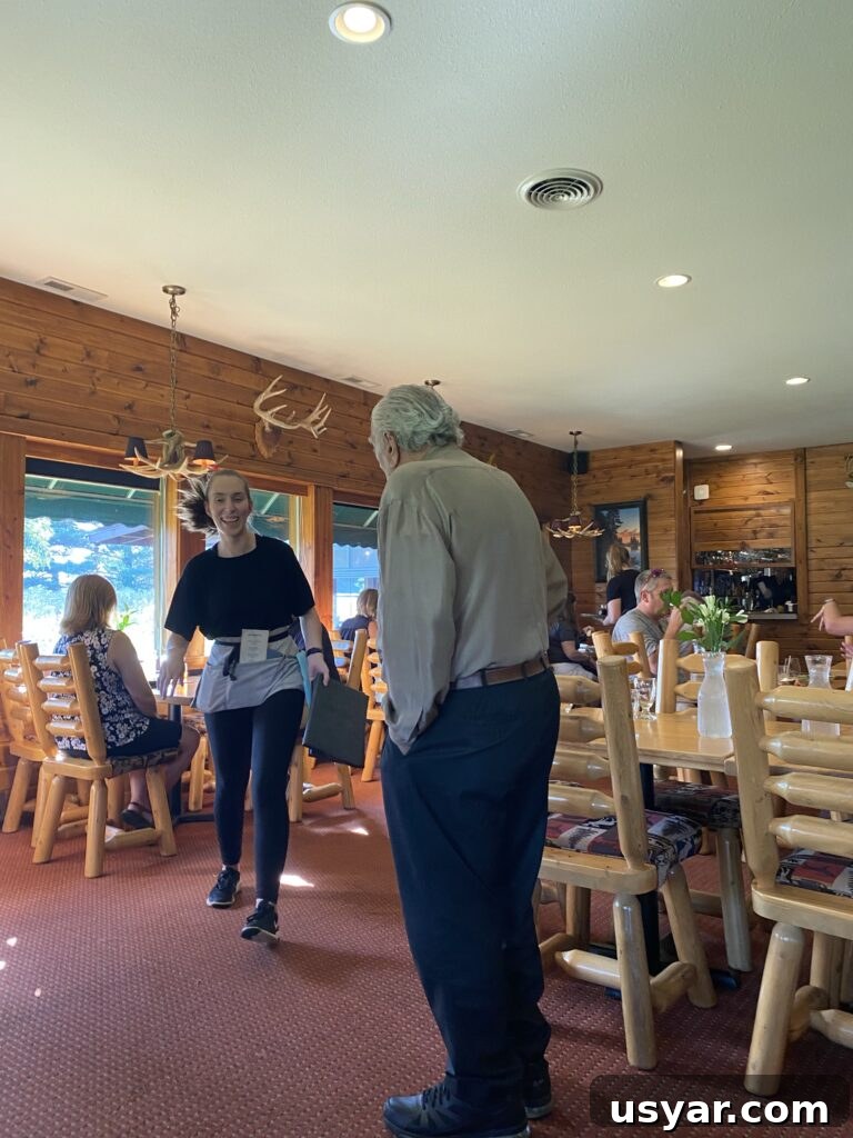 Chef Rene's at The Inn: Seasonal Cuisine in Eagle River, WI 4 The inside of the Chef Rene restaurant with customers eating at their tables, a waitress, and Chef Rene's dad