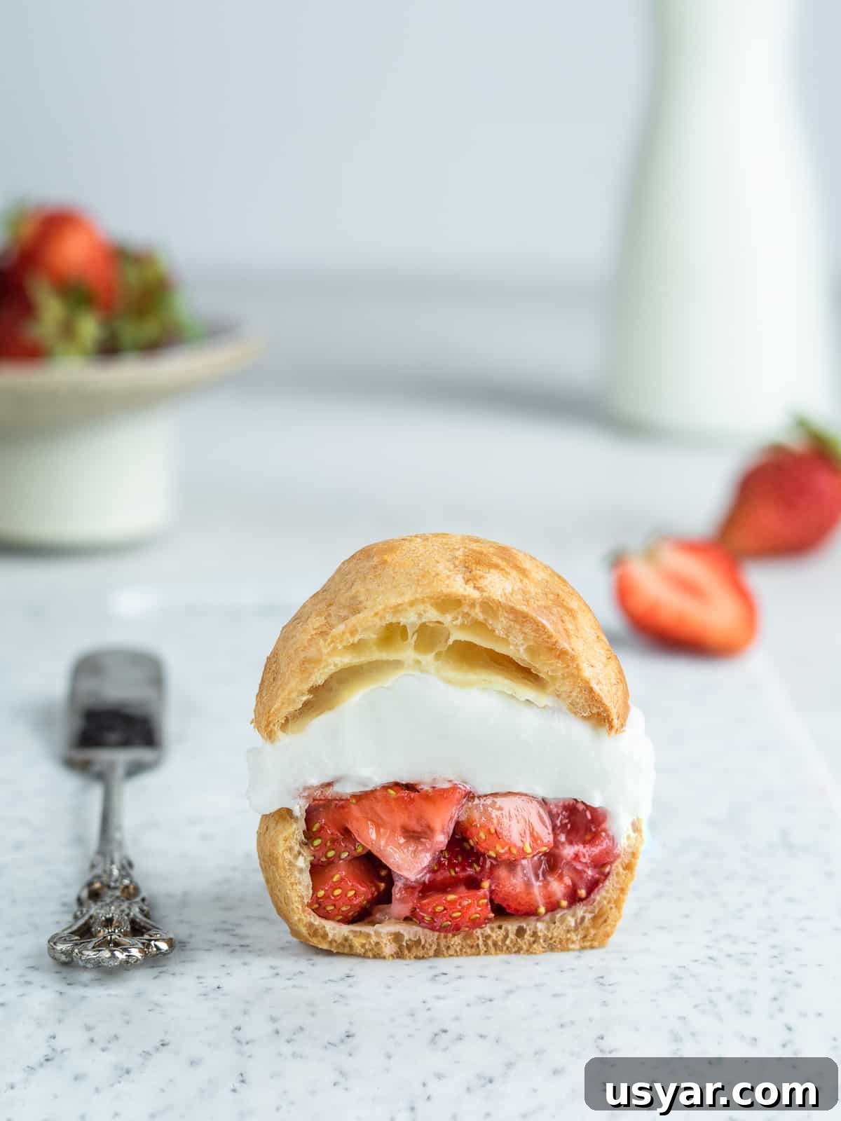 Shu Cream Japanese Cream Puffs Recipe with Custard Filling 3 Japanese cream puff with strawberries with fresh berries in the background