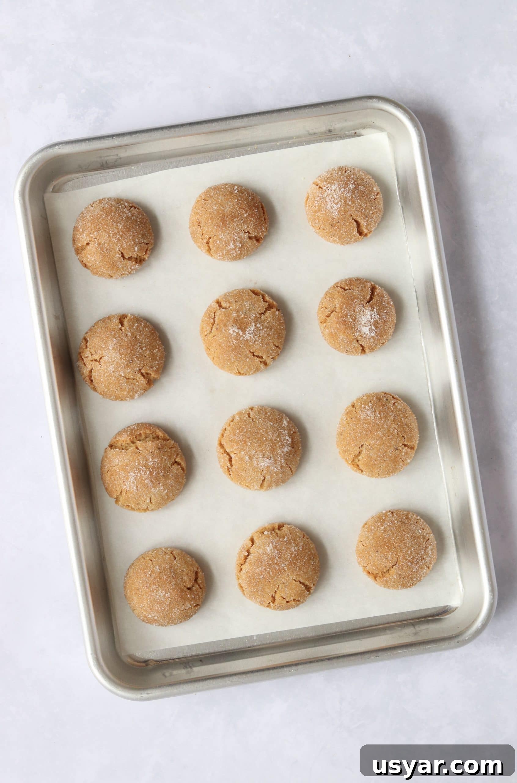 Chewy Brown Butter Sugar Cookies Recipe 5 baked brown butter sugar cookies on a baking sheet.