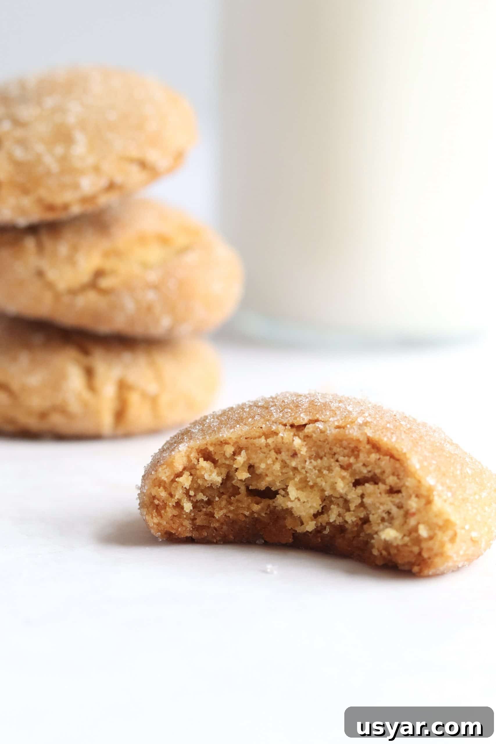 Chewy Brown Butter Sugar Cookies Recipe 7 Chewy and thick brown butter sugar cookie with a bite taken and a glass of milk