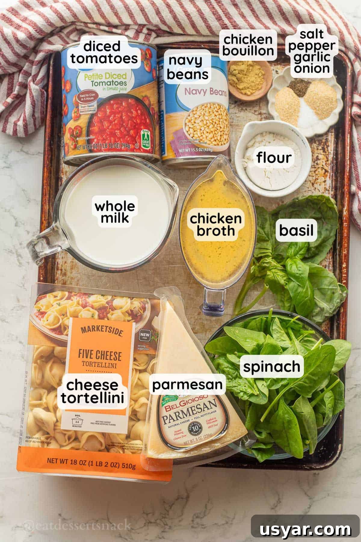 Tuscan Tortellini Soup with Tomatoes and White Beans 3 Labeled ingredient for tomato white bean tortellini soup in glass bowls on metal baking sheet.