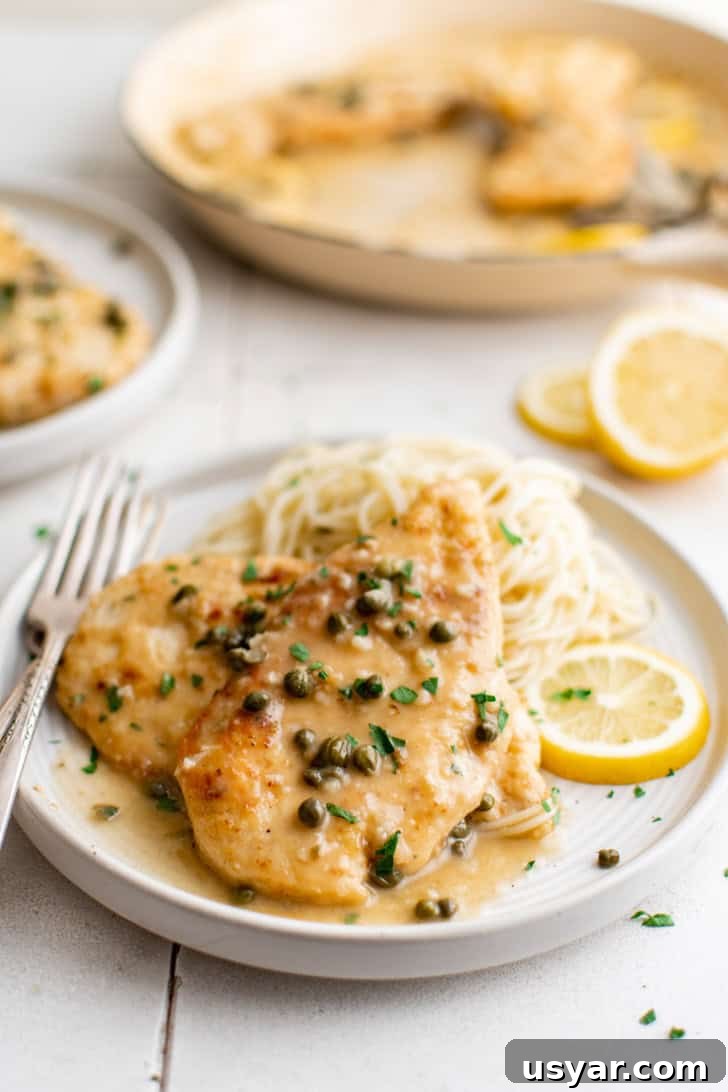 Chicken piccata over pasta.