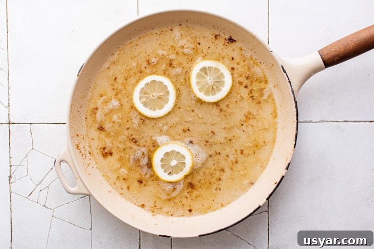 Lemon juice, wine, and garlic in a pan.