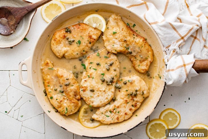 Overhead view of chicken piccata in a skillet.