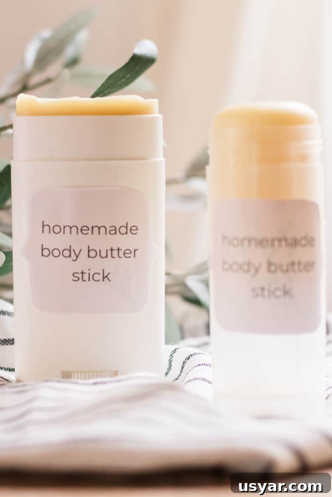 Lotion bar sticks on towel with greenery behind them.