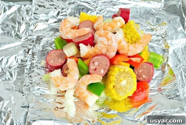 Cajun Shrimp Boil Foil Packets for Grill or Oven 6 Chopped veggies, shrimp, and sausage on foil