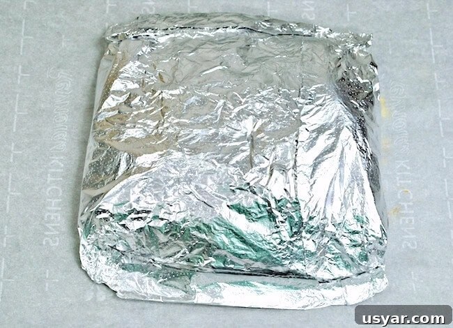 Cajun Shrimp Boil Foil Packets for Grill or Oven 7 Sealed foil packet on countertop, ready to cook