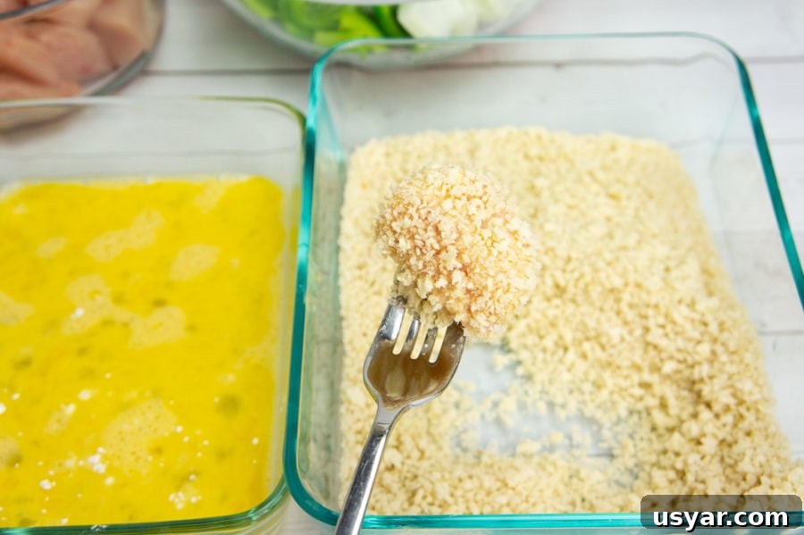 a piece of chicken coated in egg and breadcrumbs