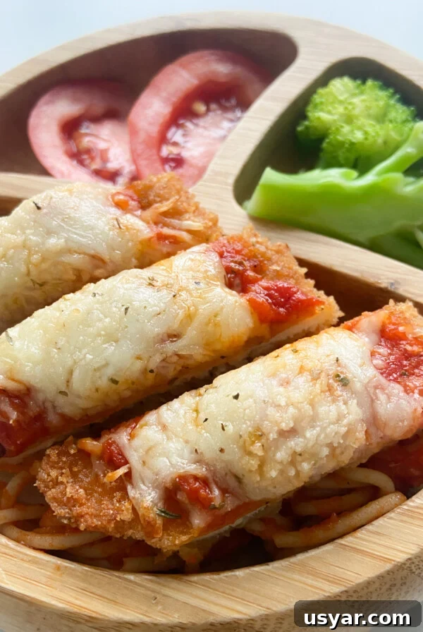 Crispy chicken parmesan served with tomatoes and broccoli.