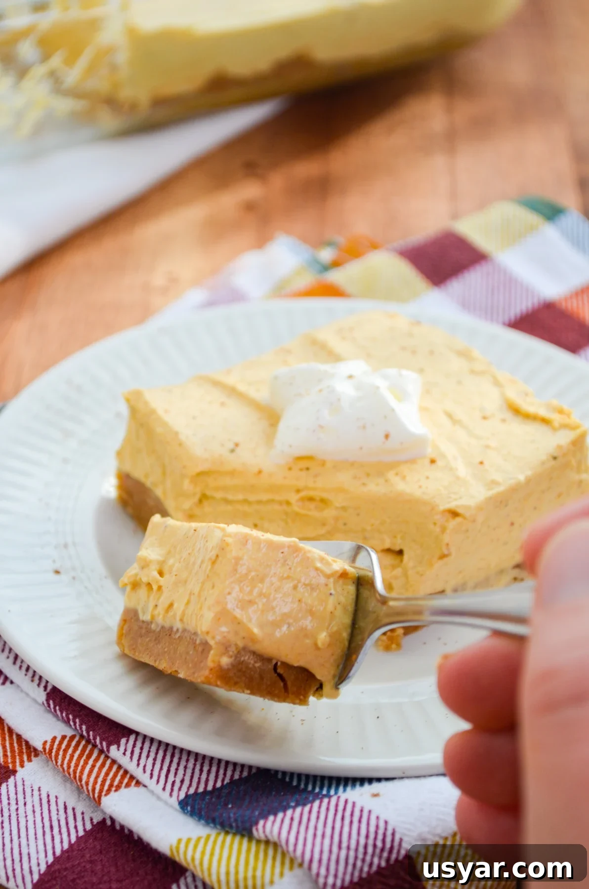 A slice of pumpkin cheesecake bars.