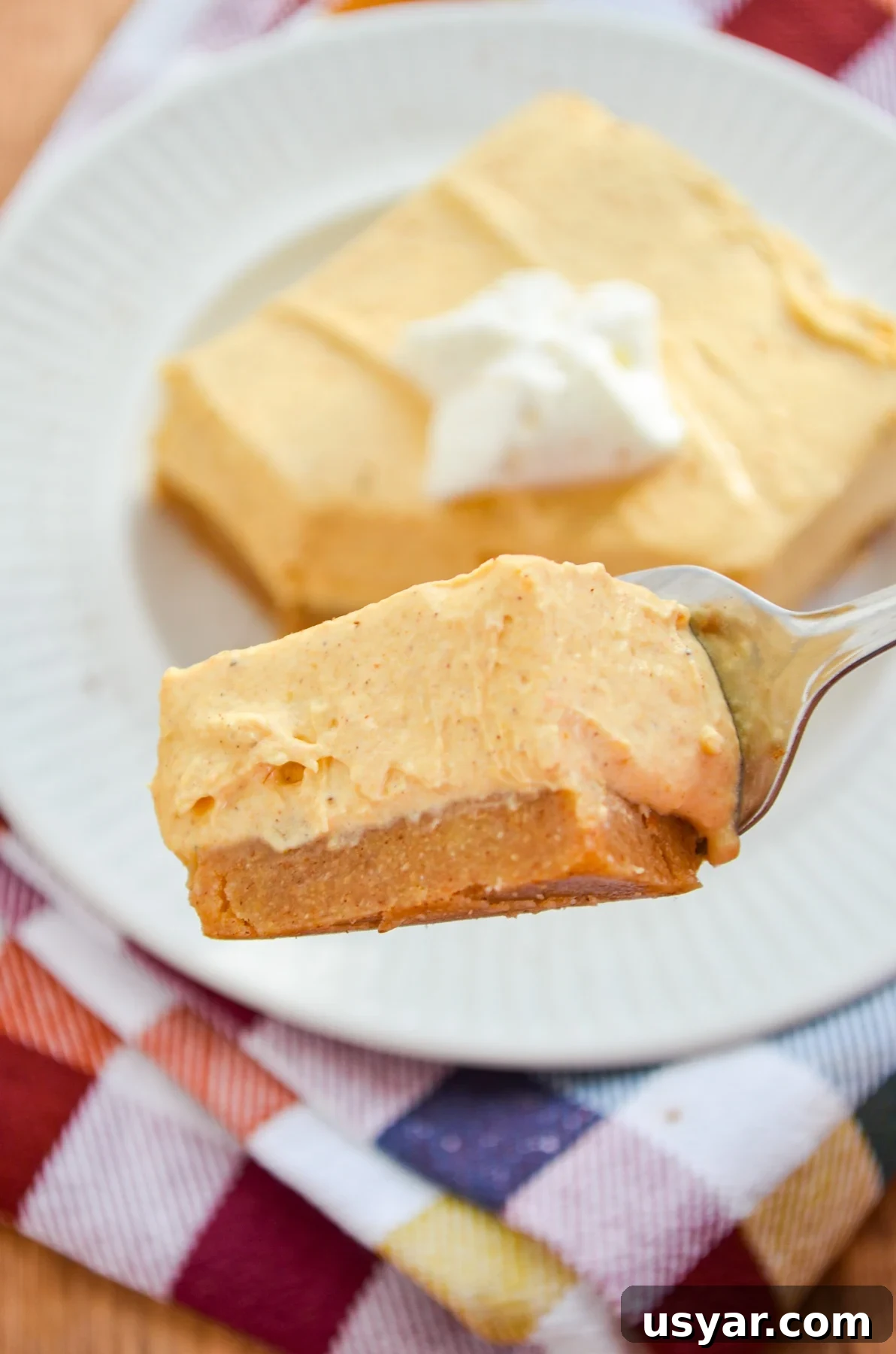 A piece of no bake pumpkin cheesecake on a fork.