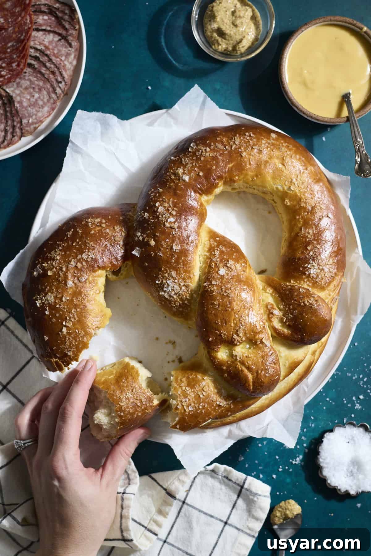 A Sourdough Discard Jumbo Pretzel on a white platter.
