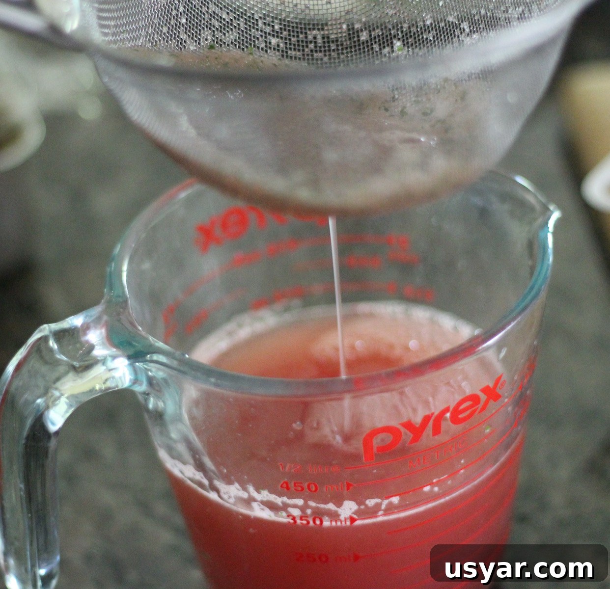 Strained watermelon mint mixture for a smooth sparkling agua fresca