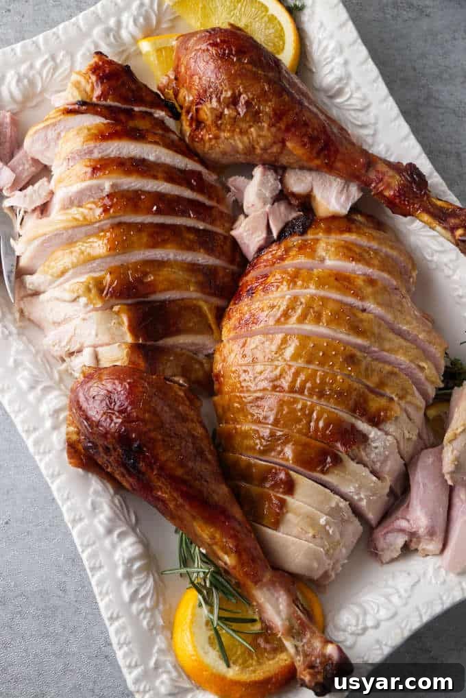 Bourbon brined Traeger turkey sliced and placed on a serving platter.
