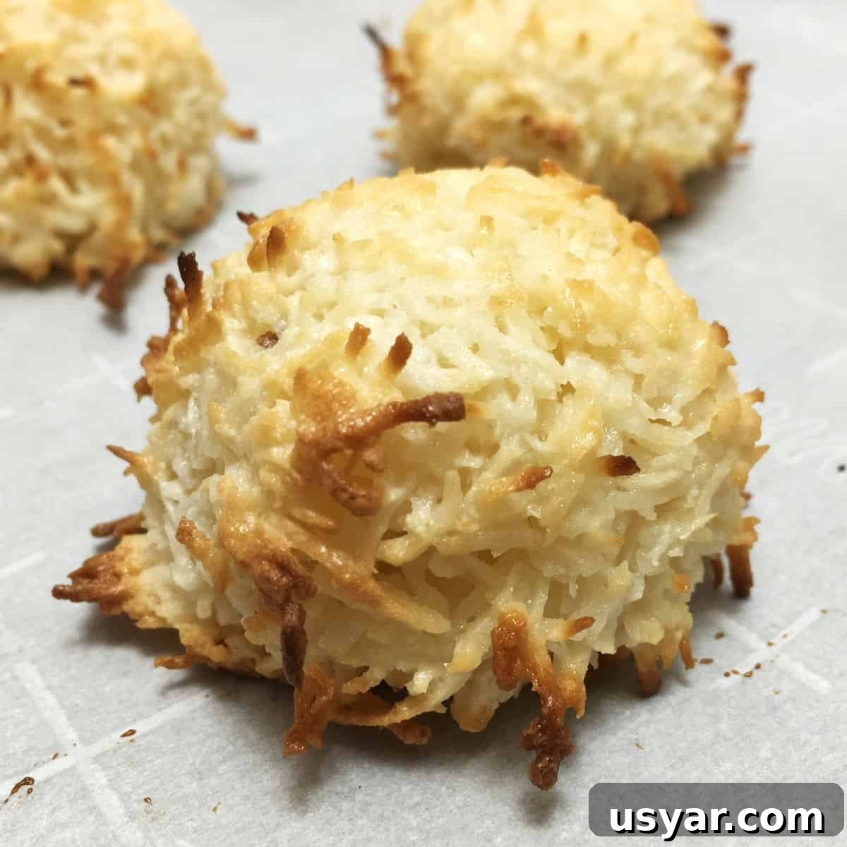 Coconut Macaroons: Congolais vs Rochers Coco 2 Three baked macaroons on parchment paper