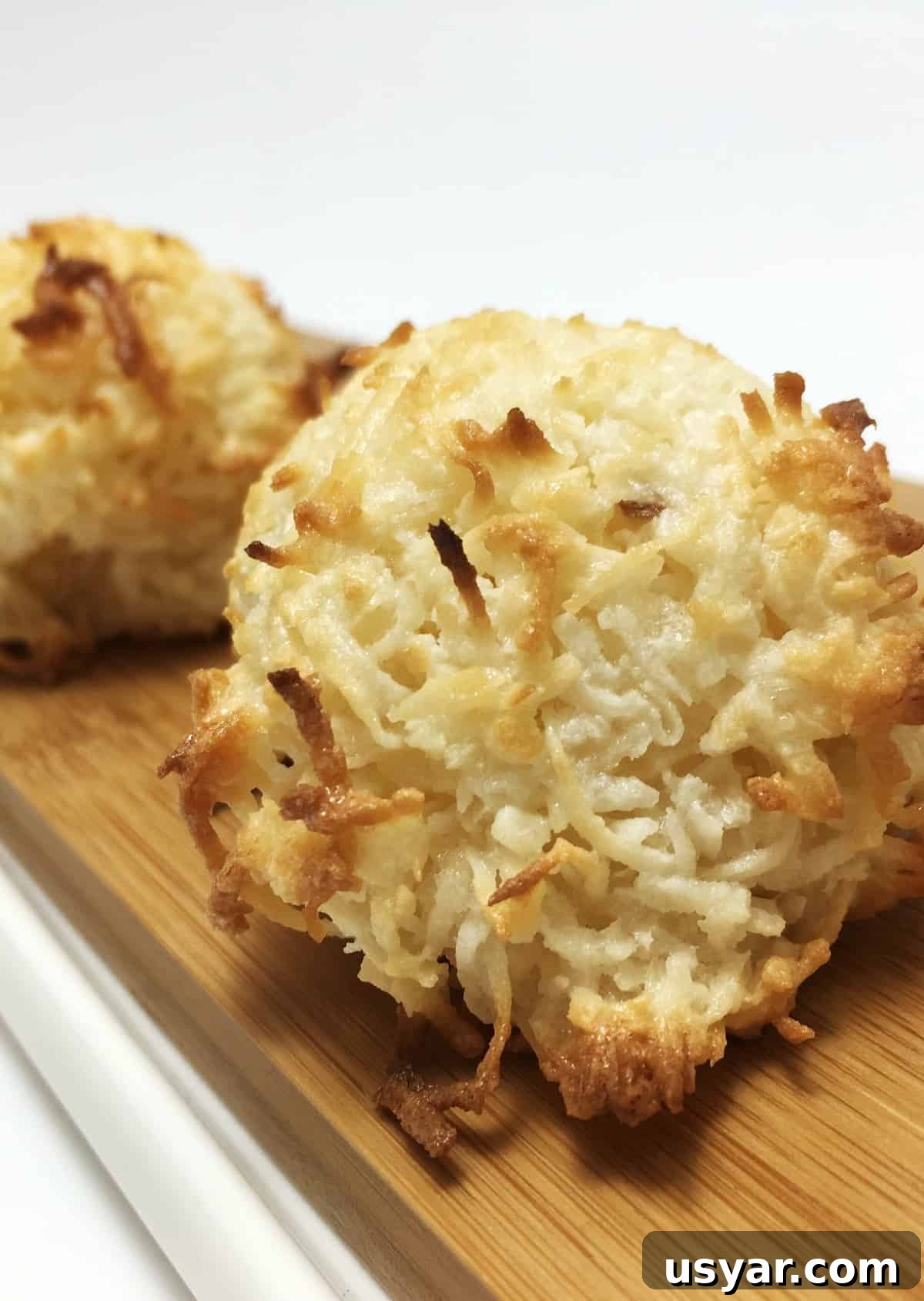 Coconut Macaroons: Congolais vs Rochers Coco 4 Coconut macaroon cookies or rochers coco on a wooden board