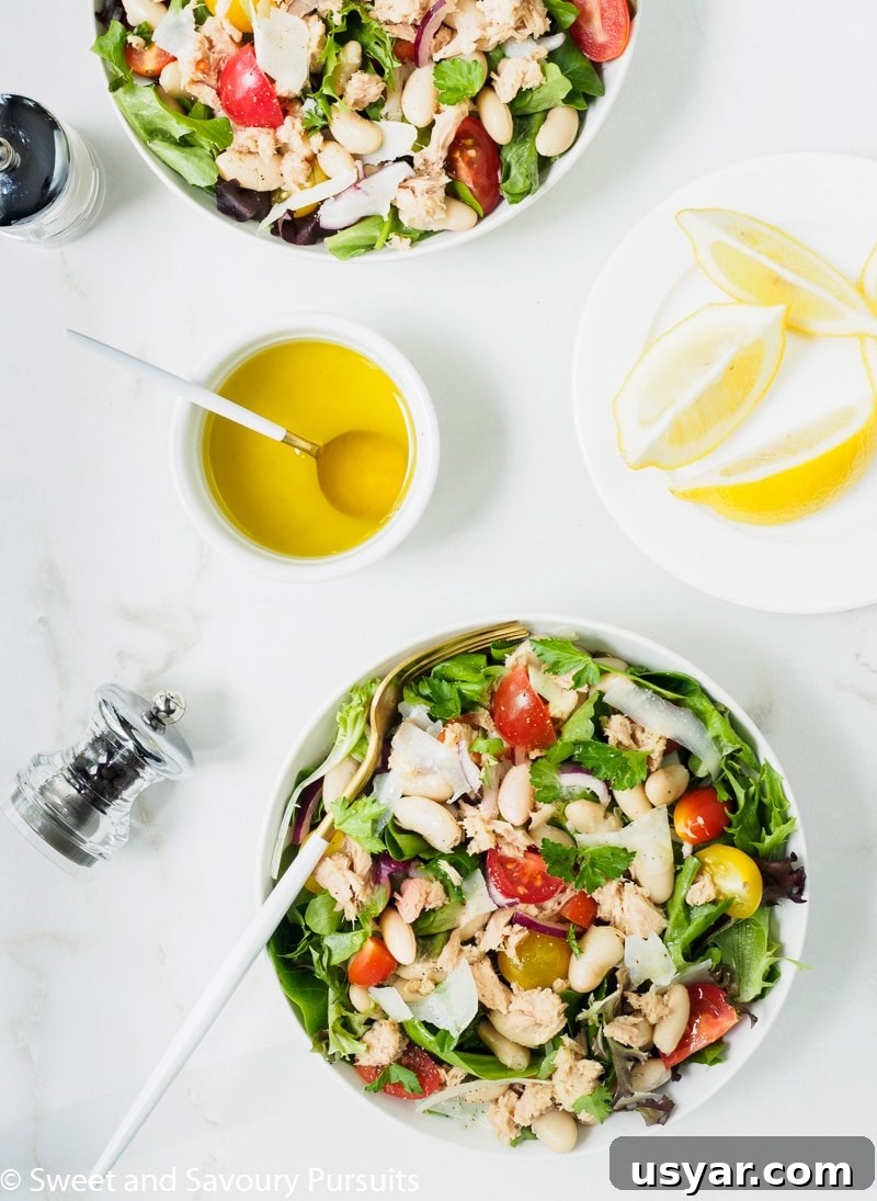Mediterranean White Bean and Tuna Salad Recipe 3 Bowls of Bean and Tuna Salad served with a lemon and olive oil dressing on the side.