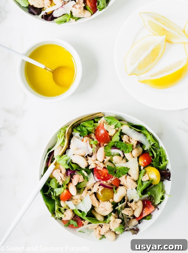 Mediterranean White Bean and Tuna Salad Recipe 5 A bowl of White Bean and Tuna Salad served with a lemon and olive oil dressing on the side.